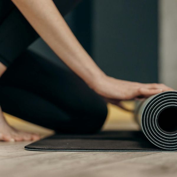 Person meditating peacefully in a bright, calm room.